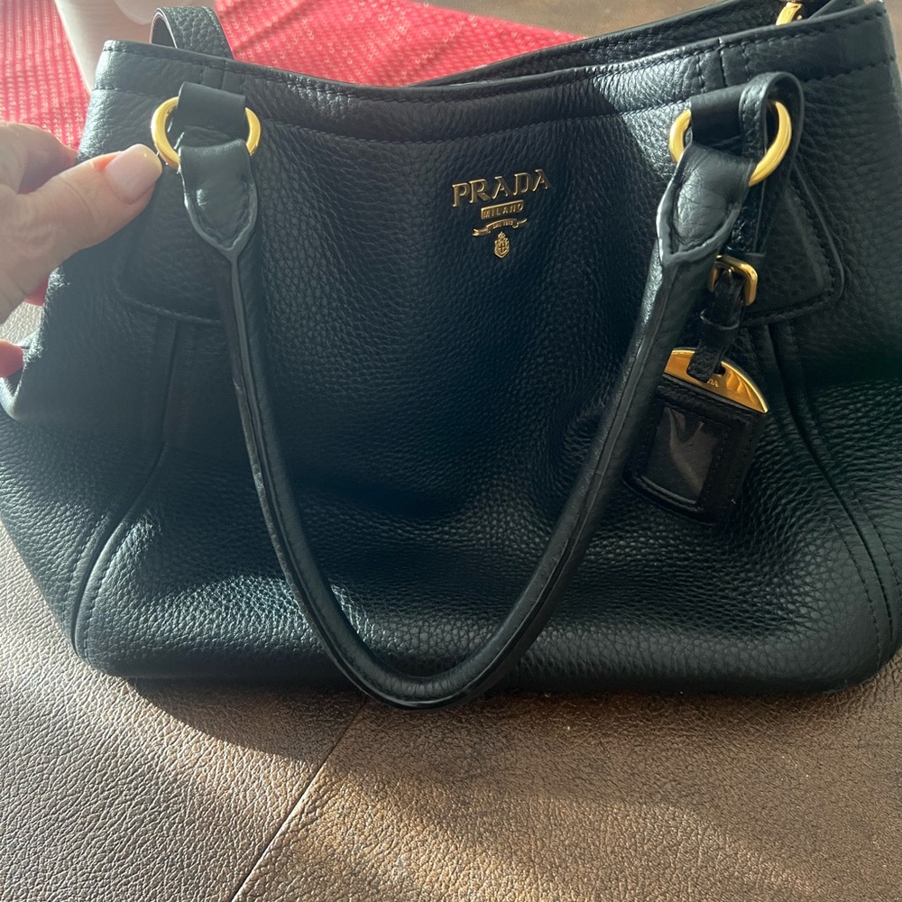 Prada authentic black leather bag / crossbody strap included.